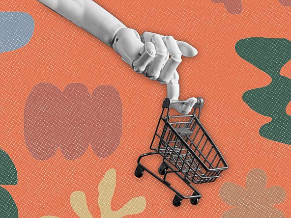 robotic hand holding a shopping trolley against orange patterned background